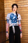 Smoke Show Tie Front Tee front view showing fitted black tie front top with smoky graphic print and short sleeve silhouette