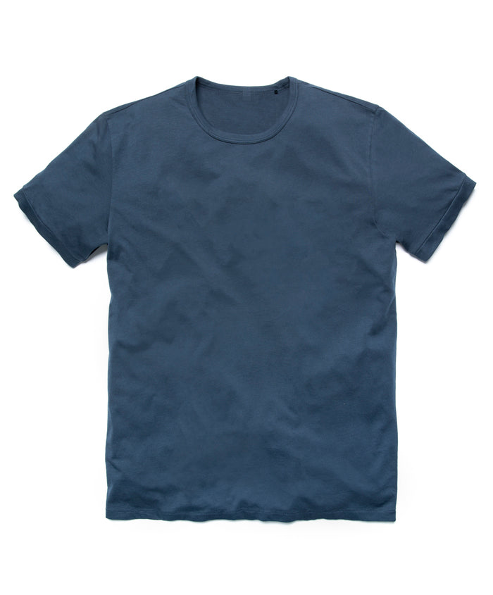 A navy blue crew neck t-shirt laid flat on a plain surface.