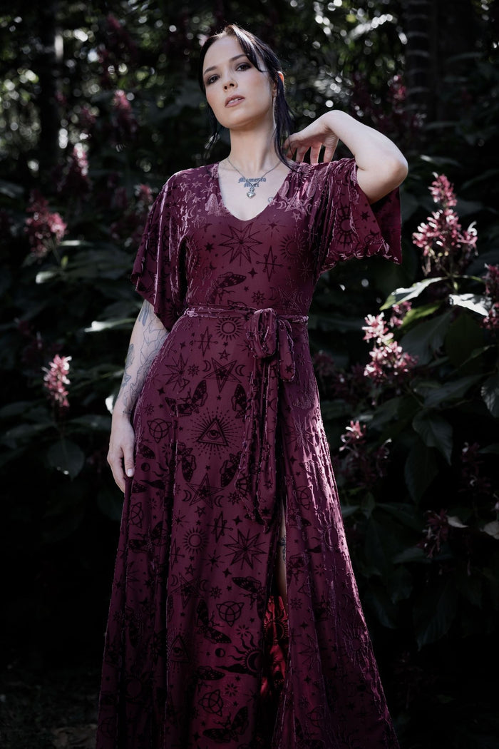 Gothic witch maxi dress with berry burned velvet, celestial sigils and flowing kimono sleeves inspired by mystical spellbook aesthetics. Featuring a fitted V-neck bodice and thigh-high split, this whimsigoth dress is perfect for fantasy witch and alternative goth styling.