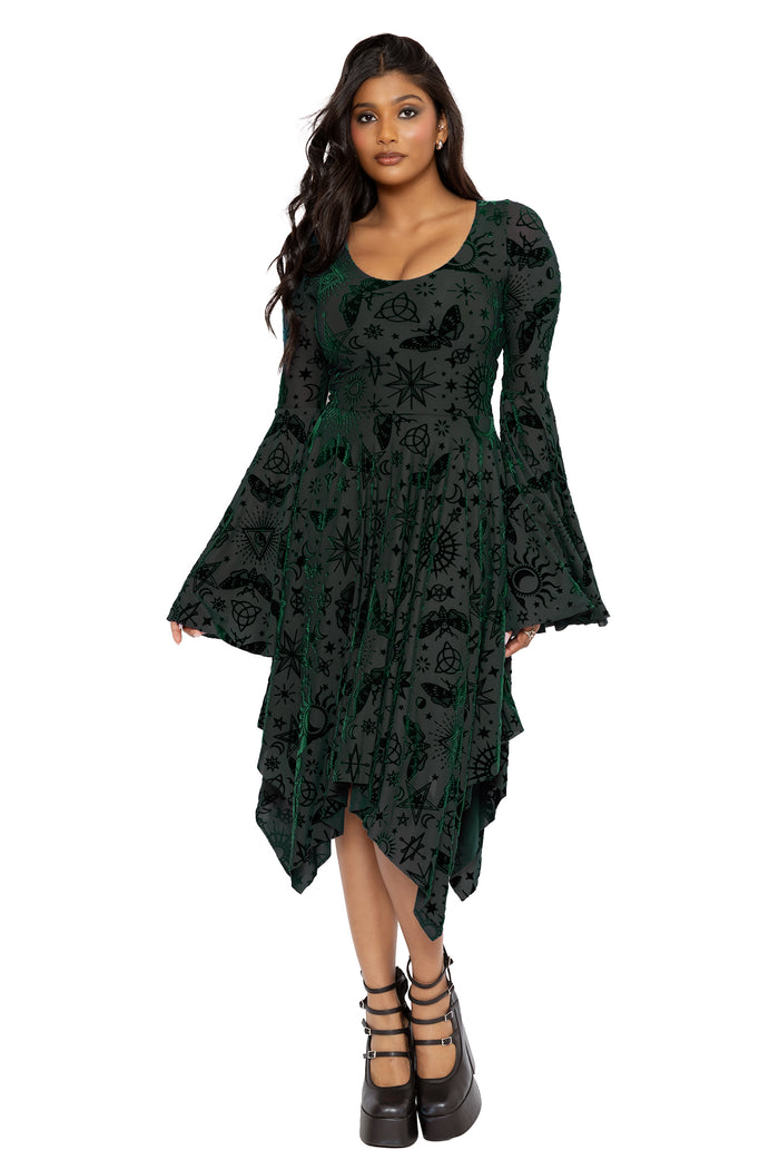 Alternative witchcore burned velvet dress featuring occult sigils, moons, stars and mystical symbols scattered across sheer pine green mesh. Designed with dramatic bell sleeves and a floaty handkerchief silhouette, this fantasy witch dress captures gothic and pagan fashion energy.