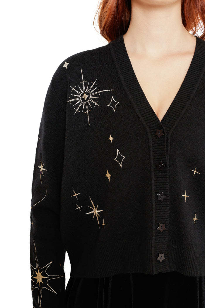 Celestial-inspired black cardigan featuring embroidered gold stars and constellation-style details