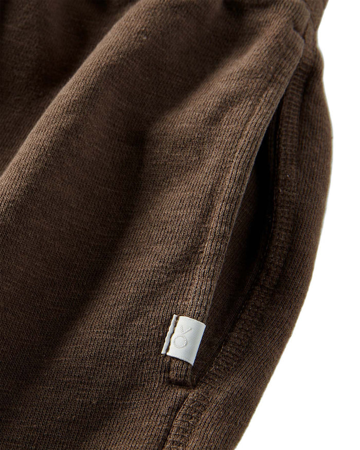 Close-up of a brown fabric with a white label on a white background