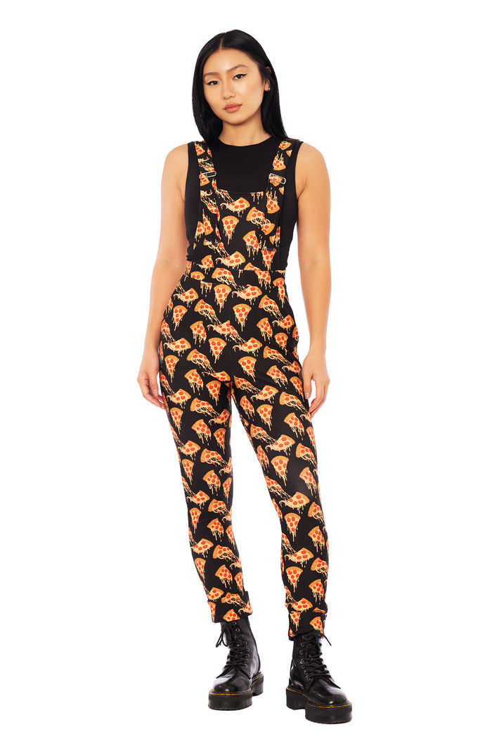 Model wearing BlackMilk Take a Pizza My Heart overalls made from stretchy matte fabric with adjustable straps and a fitted leg