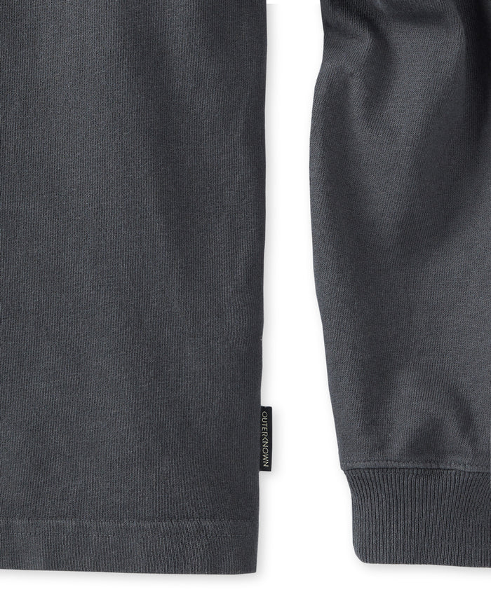 Closeup of seem and long sleeve of black long-sleeved shirt