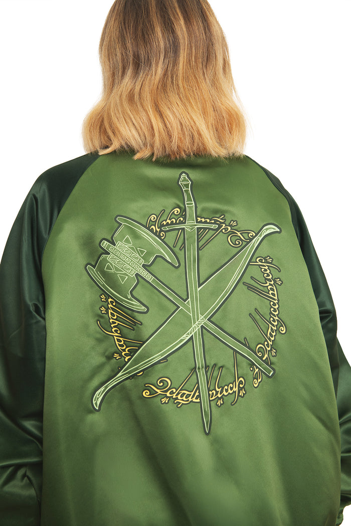 Full-length styled look of the BlackMilk Fellowship Souvenir Jacket in green, paired with black bottoms and boots for a Lord of the Rings-inspired streetwear outfit.