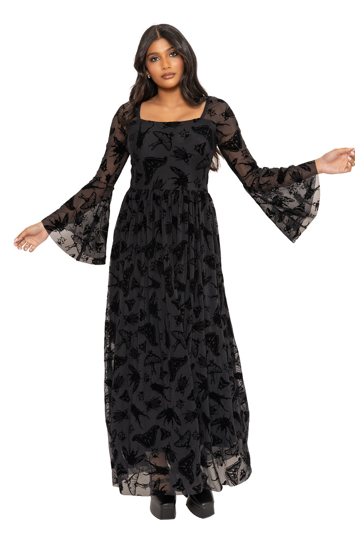 Gothic moth print maxi dress with sheer burned velvet texture and delicate insect artwork designed by Ami Raithe. Featuring a fitted bodice, dramatic flute sleeves and flowing maxi skirt, this alternative witchcore dress captures dark academia and pagan fashion vibes.