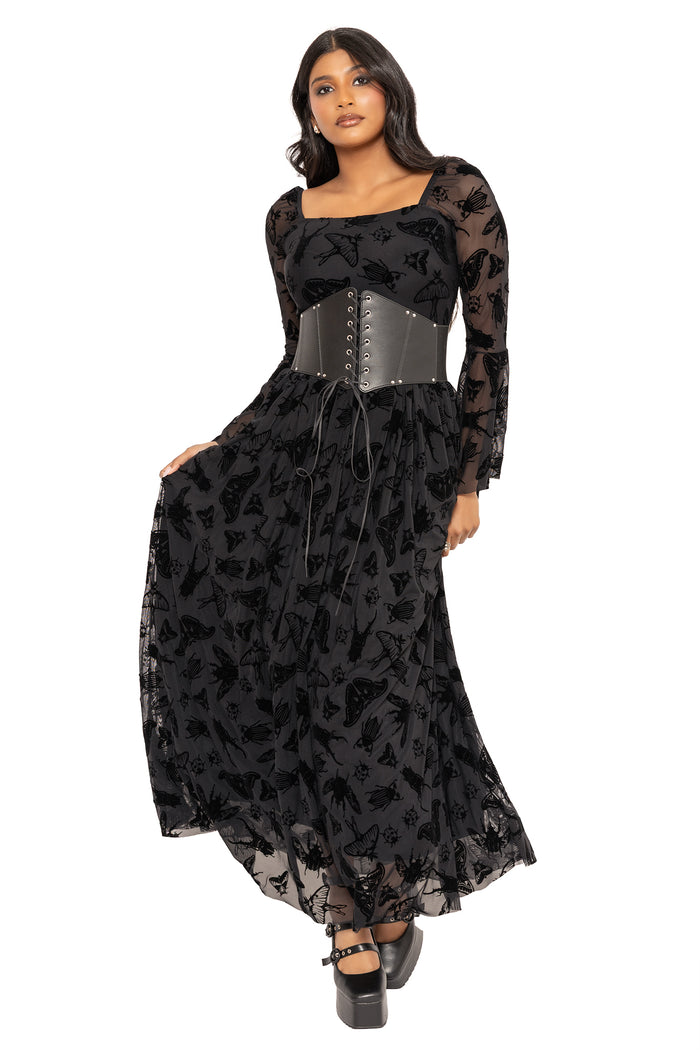 Alternative goth maxi dress with black moth and beetle artwork by Ami Raithe, inspired by cottage witch, dark academia and gothic nature aesthetics. Featuring a flattering square neckline and sheer burned velvet fabric, this fantasy witch dress is perfect for elegant witchcore styling.