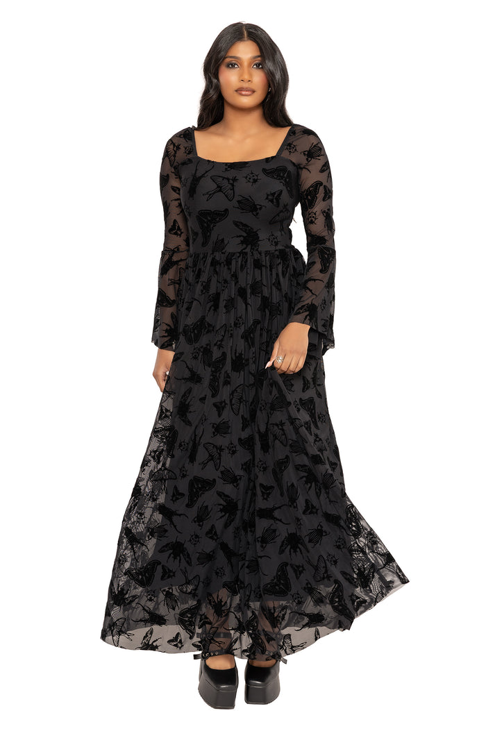 Black burned velvet flare sleeve dress with Ami Raithe moth artwork in a gothic insect-inspired design. Featuring a square neckline, fitted bodice and sheer flowing maxi skirt, this alternative goth dress is perfect for fantasy witch and modern pagan styling.