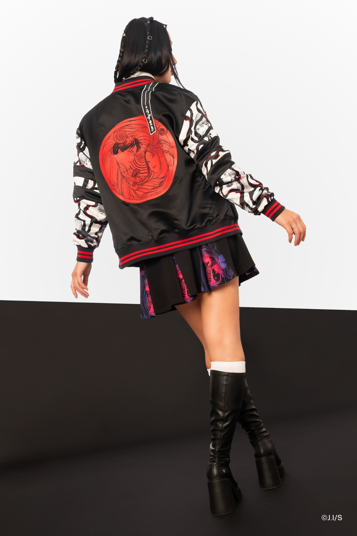Back view of Junji Ito x BlackMilk Uzumaki satin varsity jacket featuring large red spiral vortex artwork with Kirie and Shuichi, black anime streetwear bomber jacket with manga print sleeves.