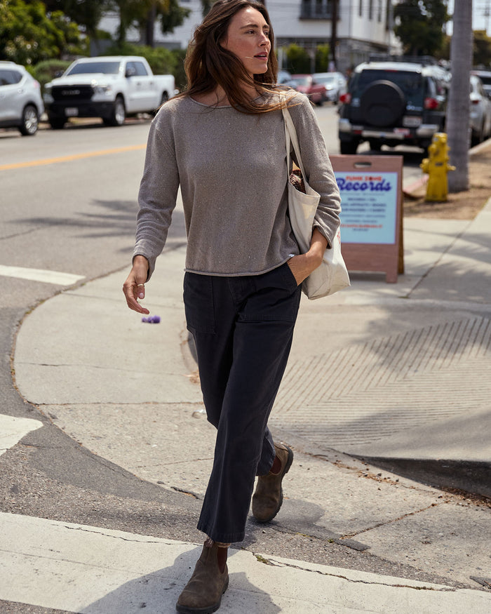 Woman walking on a sidewalk in an urban setting