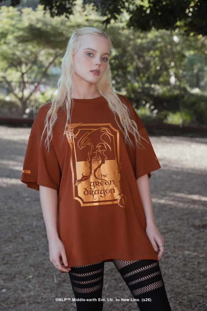 BlackMilk x The Lord of the Rings What About Elevenses? Big Tee in rust brown, a Merry and Pippin-inspired oversized tee featuring The Green Dragon pub graphic.