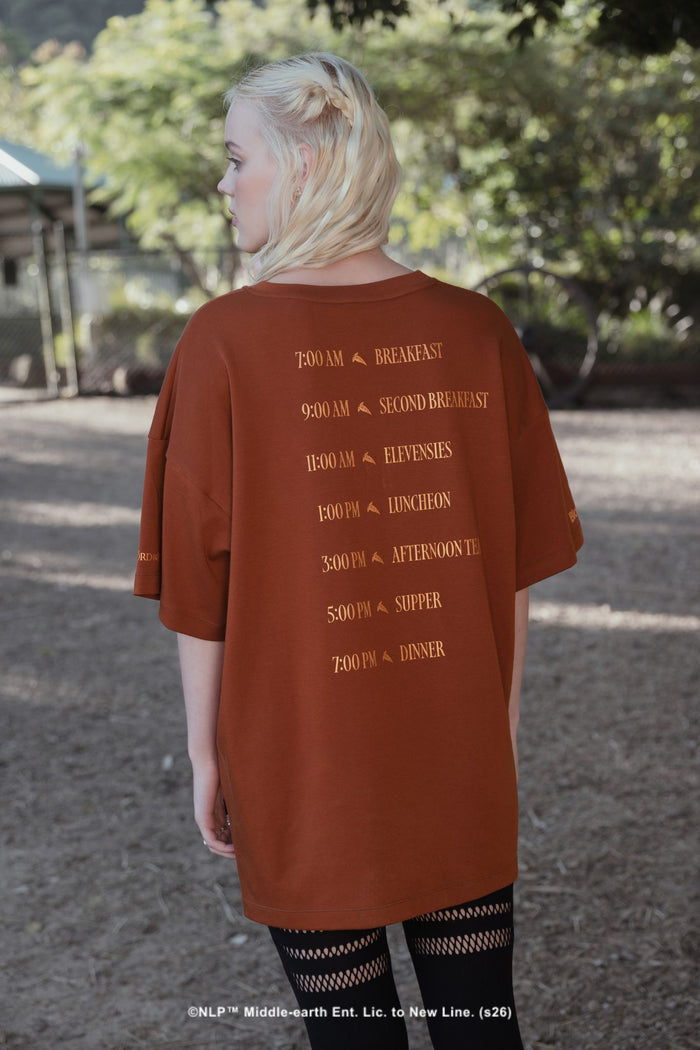 Close-up campaign shot of the What About Elevenses? Big Tee by BlackMilk, showing The Green Dragon graphic print inspired by hobbit second breakfast culture.