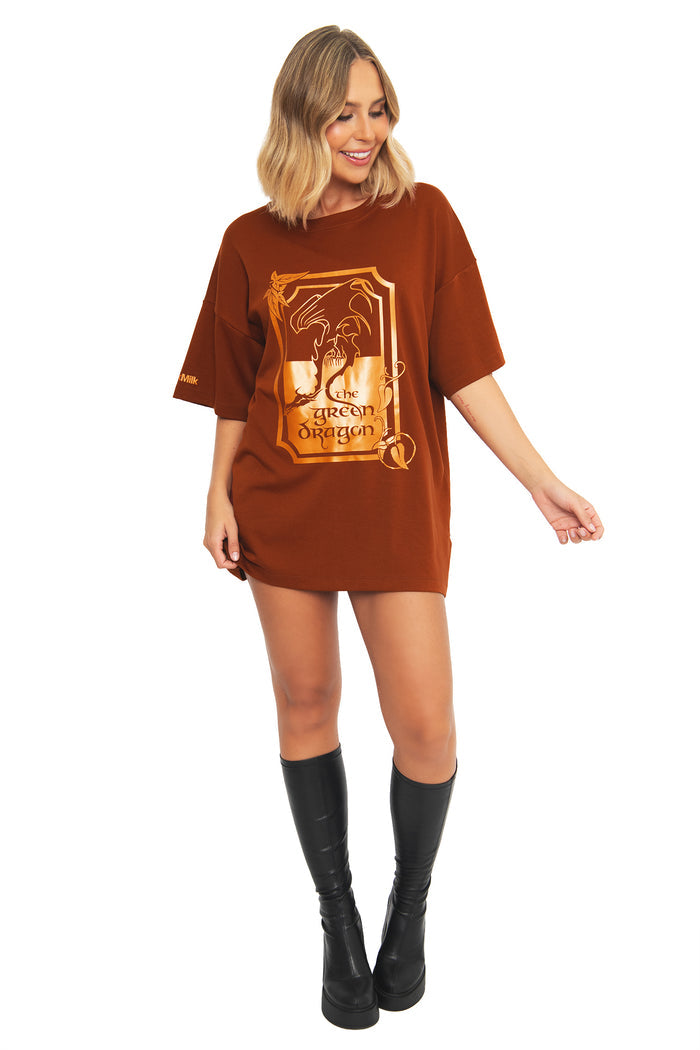 Front view of a model wearing the BlackMilk What About Elevenses? Big Tee in rust brown, featuring The Green Dragon pub graphic inspired by Merry and Pippin from the Lord of the Rings.